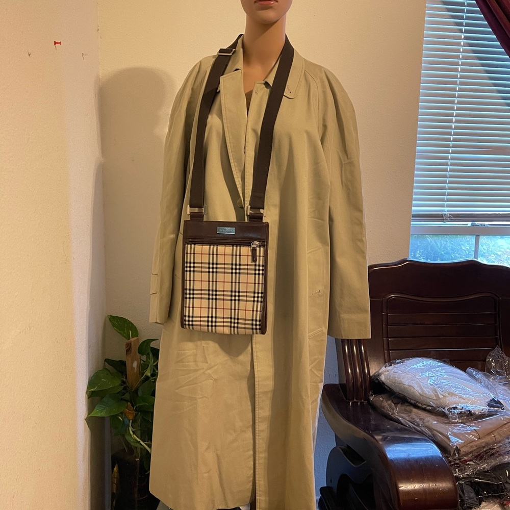 Beige in color trench coat.